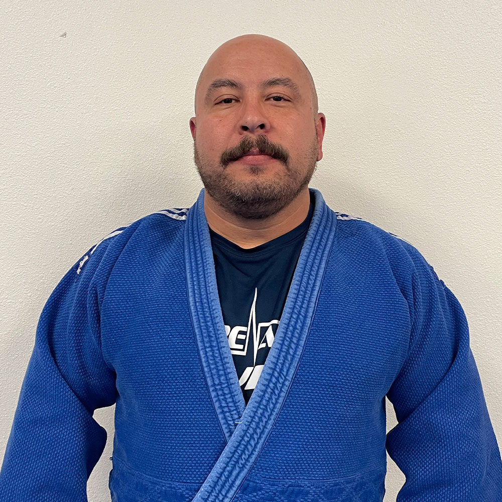 Judo Coach Sensei Jesse Duran, adorned in judo attire, at Adrenaline MMA & Fitness.